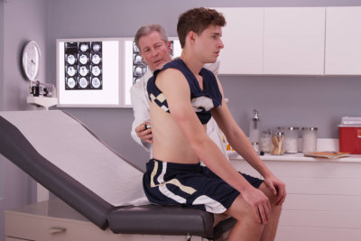 doctor checking a male athlete's body