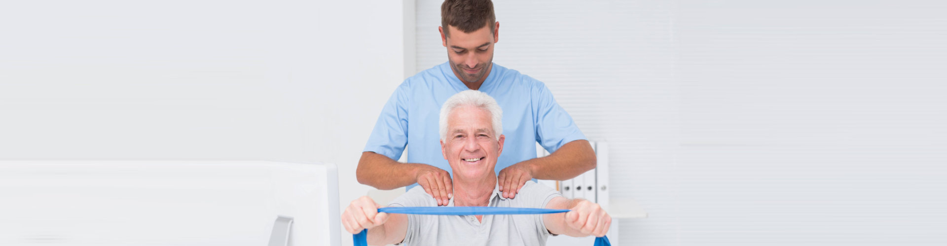 therapist massaging a senior man